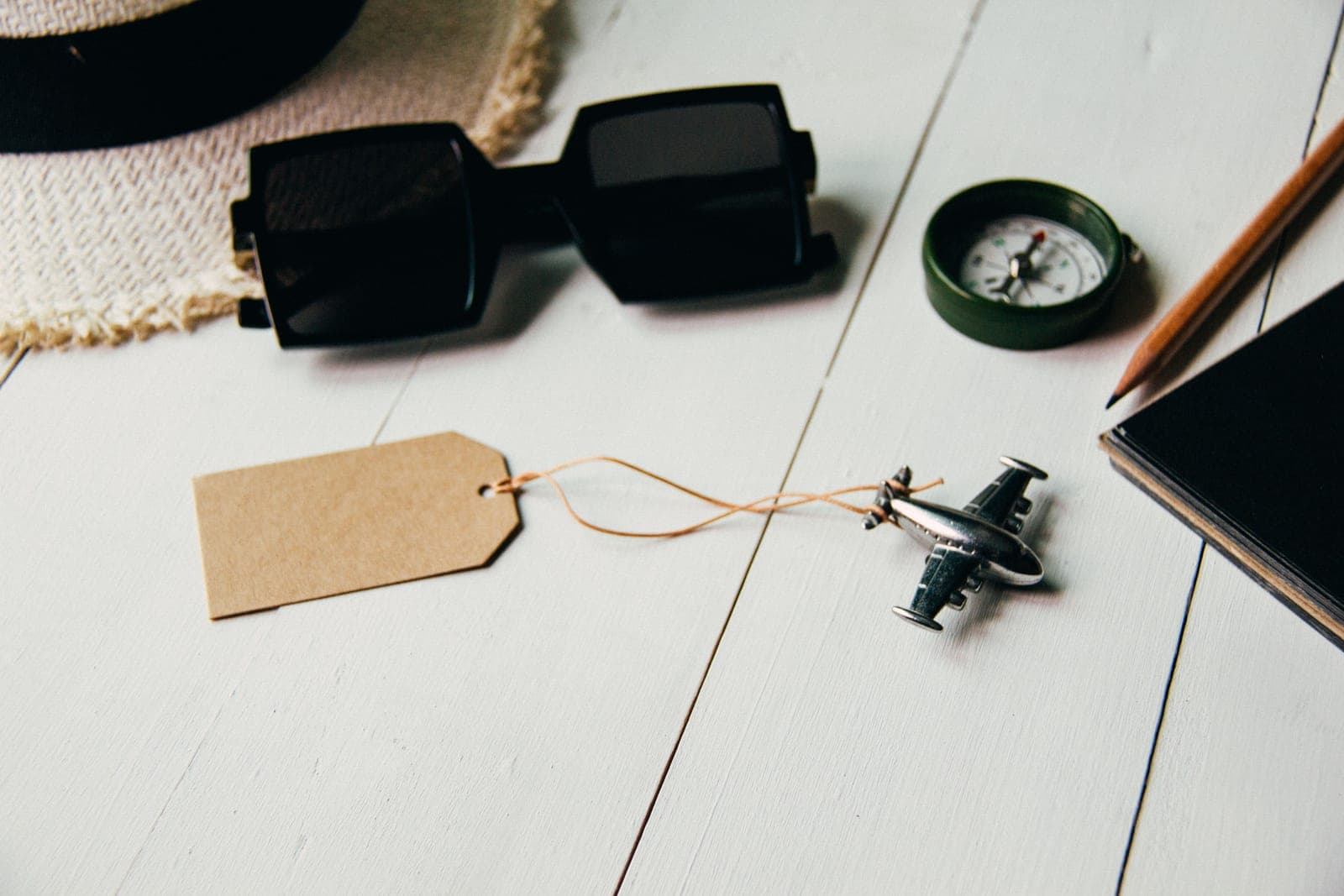Several pairs of sunglasses laid out on a warm neutral background